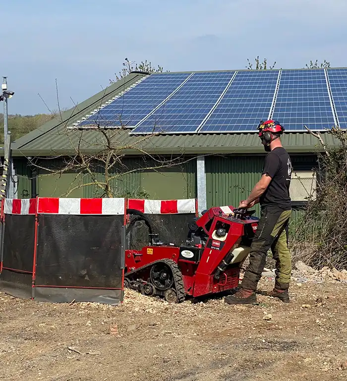 Seasonal Grounds Maintenance Man stump grinding around commercial offices